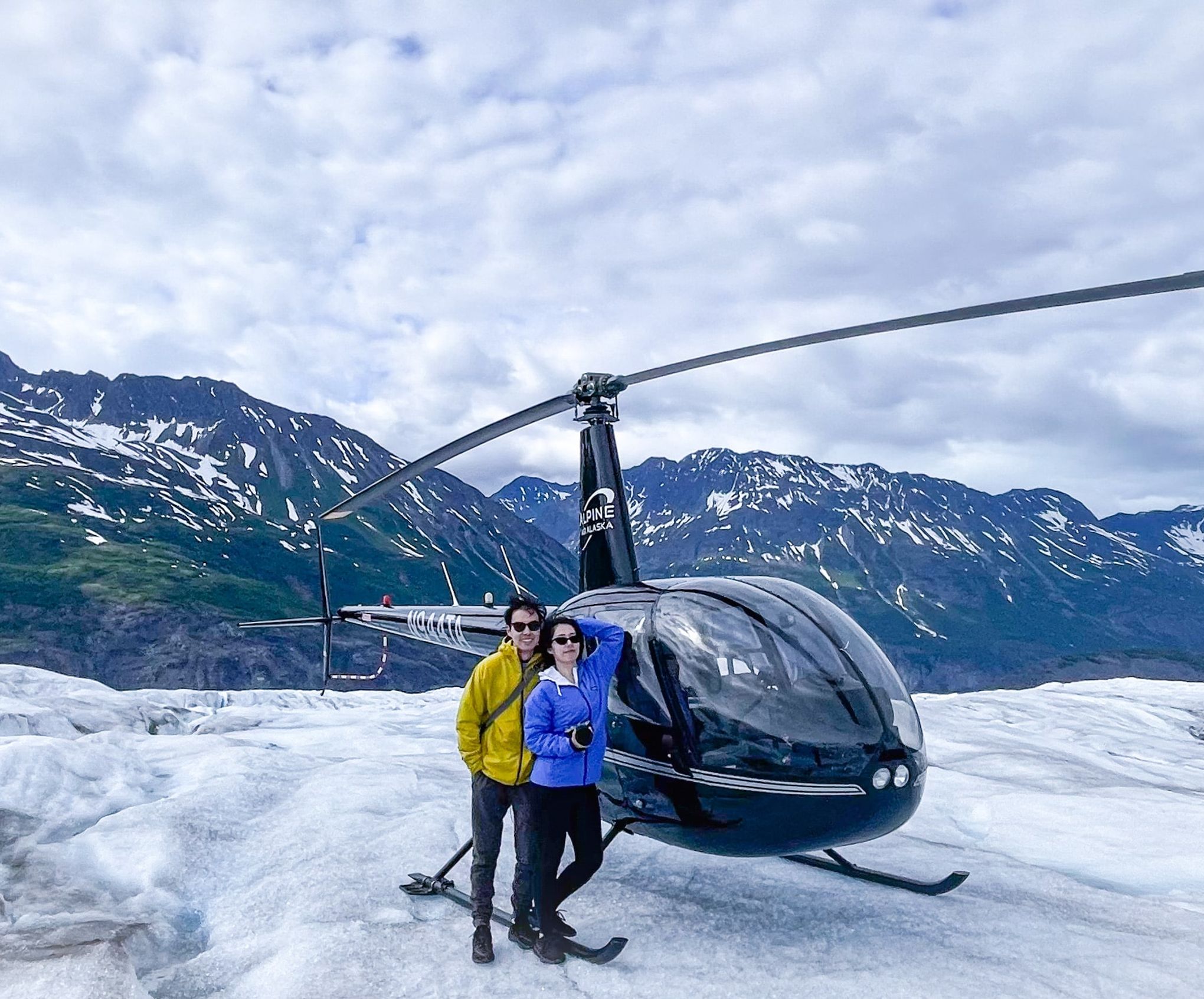 Photo in front of a helicopter in Alaska